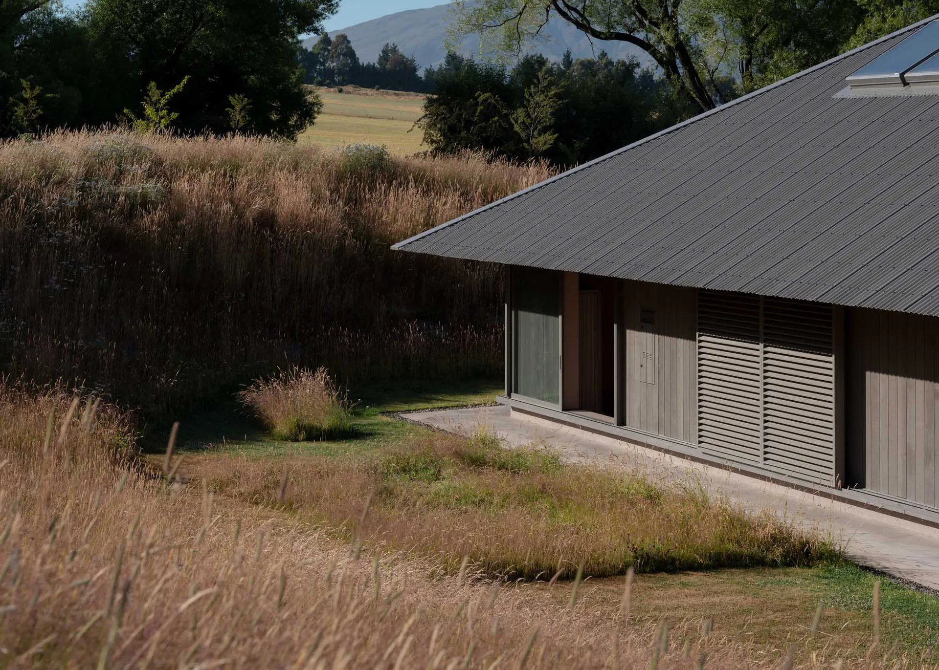 Modern exterior of a house made of metal, glass, and concrete materials.