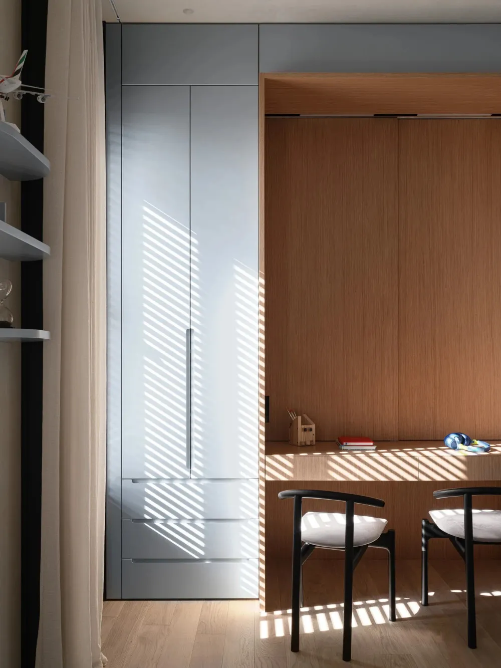 A minimalist workstation with wooden materials featuring a white cabinet and clean lines.