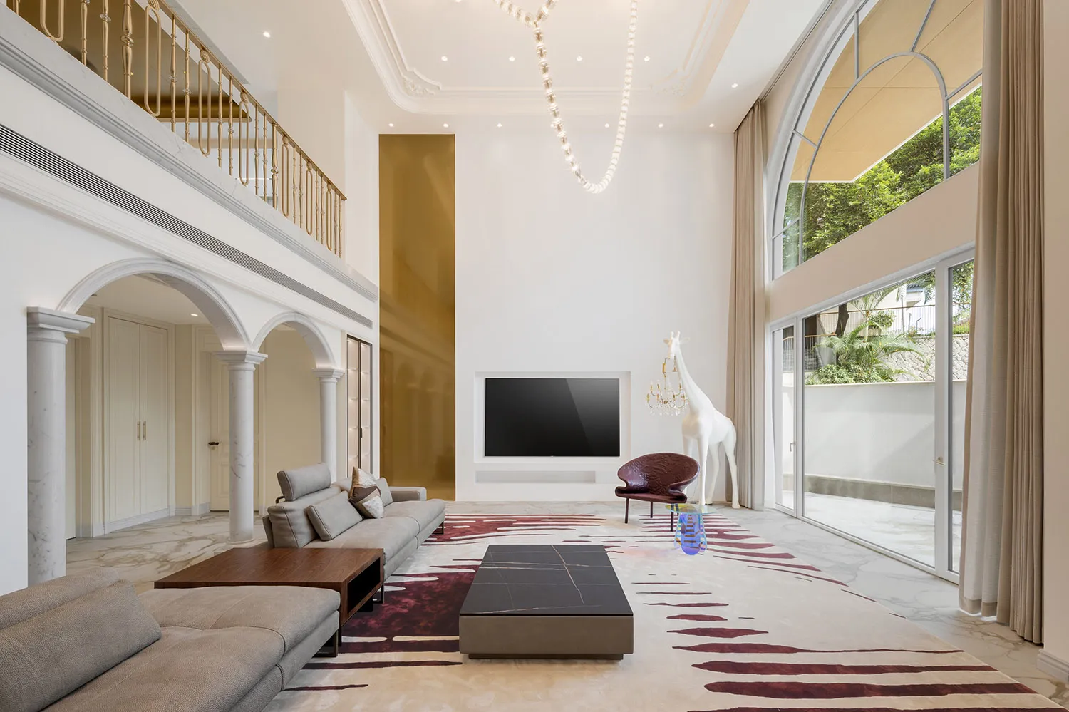 A modern minimalist living room featuring marble and glass materials, with a large TV on the wall and a giraffe sculpture.