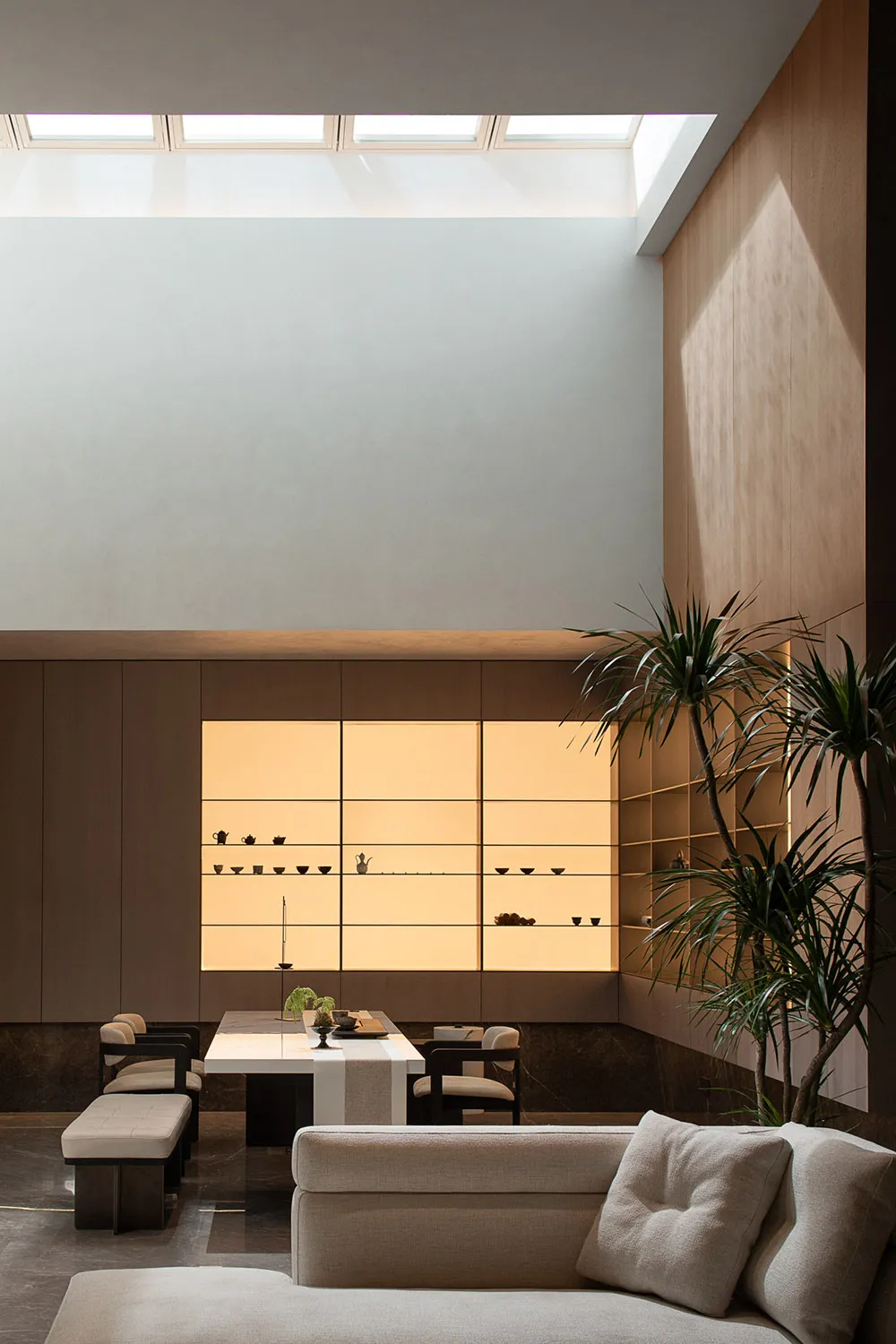 Modern living room featuring flush lighting and a plant in a contemporary setting.