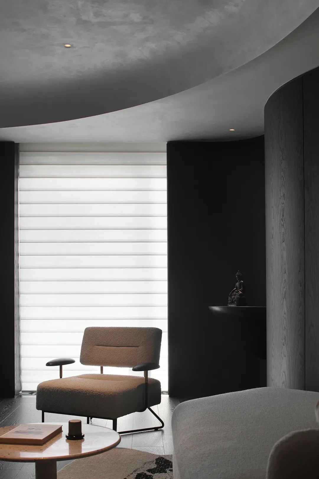 Modern living room with black walls, minimalist design, and white window blinds.
