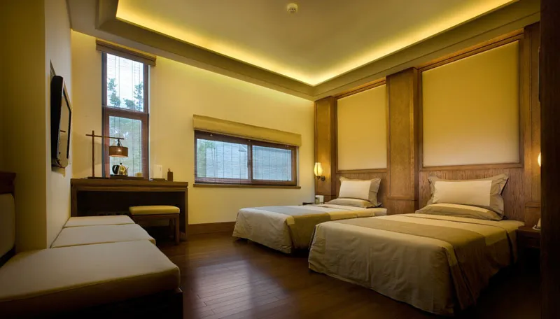 A spacious bedroom suite featuring modern design elements and wooden accents.