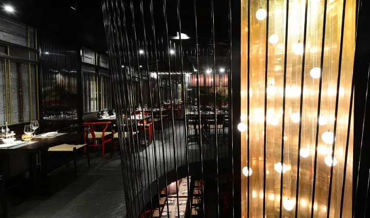 Modern restaurant interior featuring metallic lights curtain