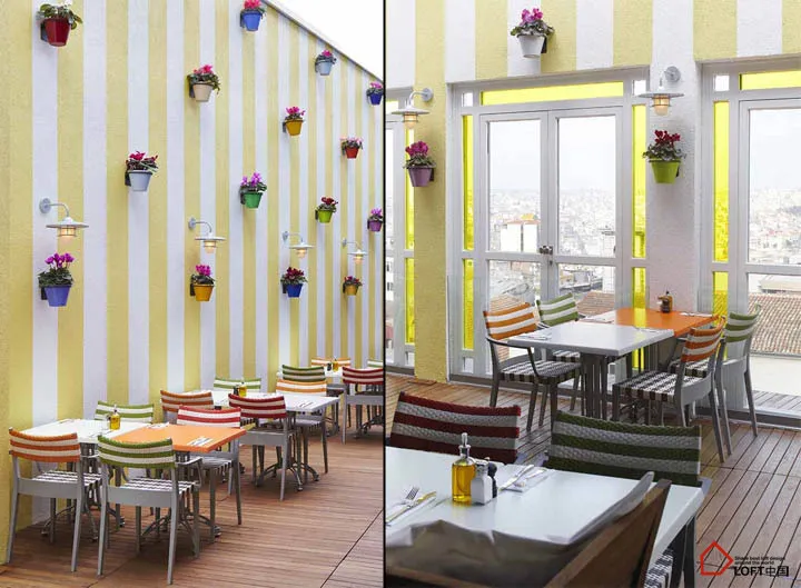Outdoor seating area of a coffee shop with concrete walls and glass windows.