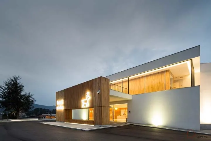 A modern building with a wooden and concrete exterior.