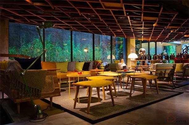 A modern coffee shop interior with wooden furniture and glass elements.