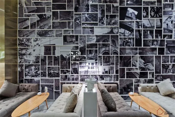 A modern interior space with black and white photographs on the wall.