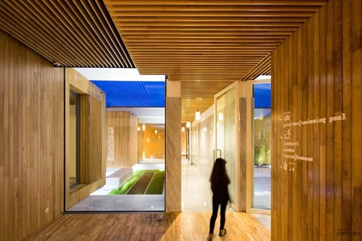 A modern lobby entrance featuring wood and glass materials