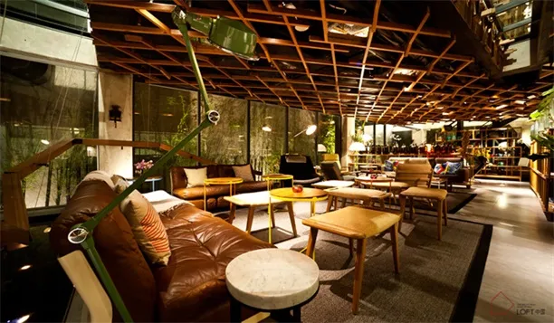 A modern loft interior with cushions and leather furniture.