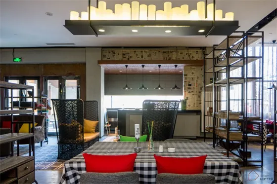 Restaurant interior with industrial design elements, featuring exposed concrete walls, metal accents, and wooden furniture.
