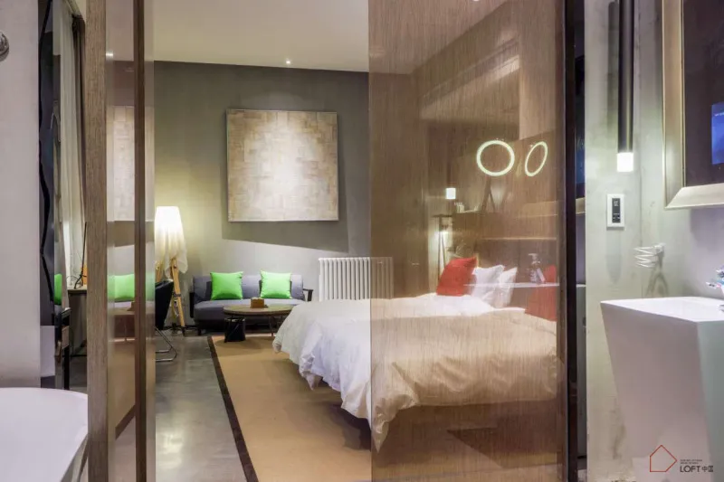 Modern minimalist bedroom featuring wood furniture, concrete walls, and fabric bedding.