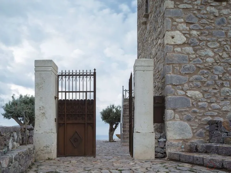 A minimalist stone gate in a landscape setting.
