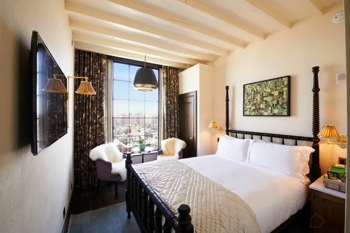 A stylish bedroom featuring modern anthropological design elements with wood and plaster