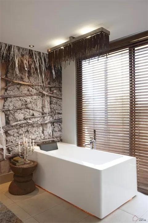A minimalist bathroom featuring a white bathtub, wooden blinds, and wooden wall decor.