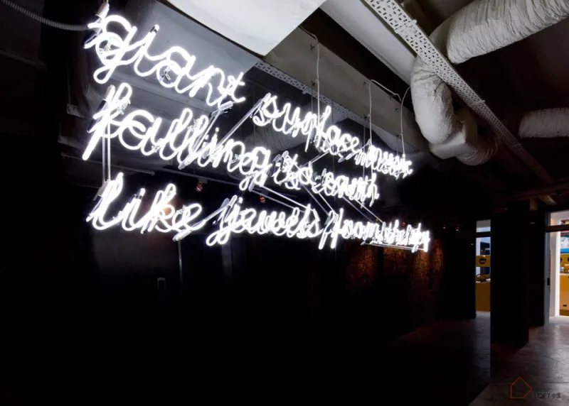 A minimalist neon sign hanging from the ceiling.