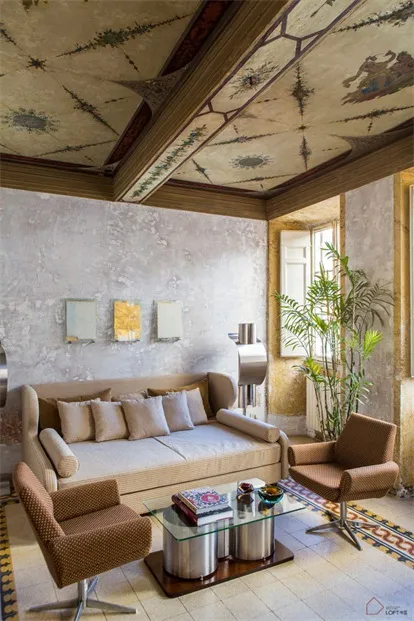 A modern residential living room featuring concrete walls and wood accents.