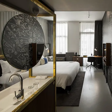 Modern, minimalist bedroom featuring a concrete desk.