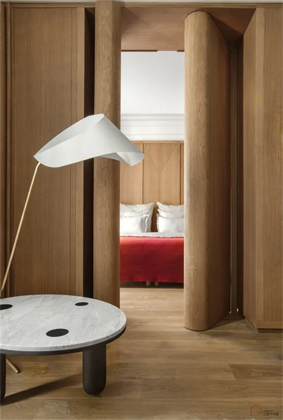 Modern bathroom featuring wooden furniture and red accents.
