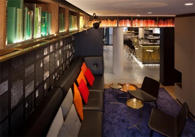 A modern, minimalist interior with a black metal reception desk, designed for a contemporary office space.