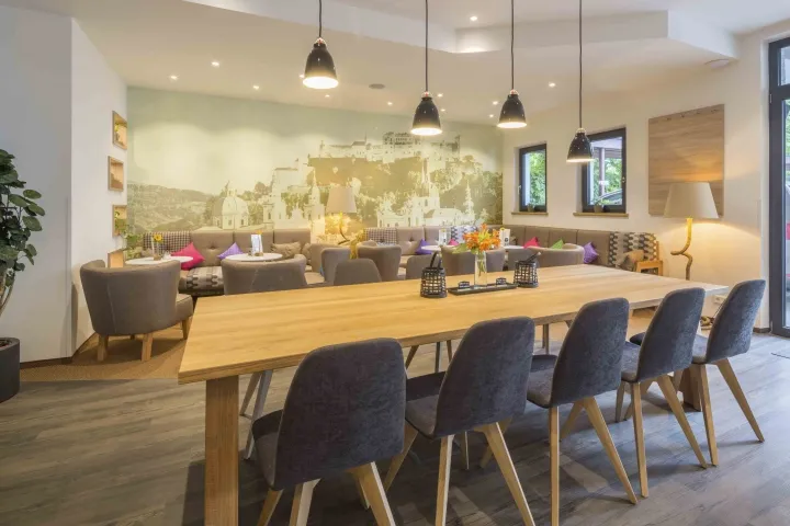 A cozy café interior with wooden furniture and comfortable seating areas.