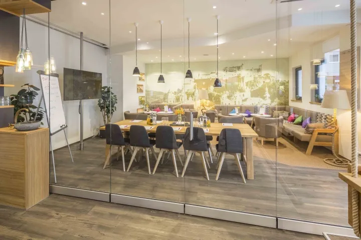 A modern office space featuring a wooden desk and seating arrangements