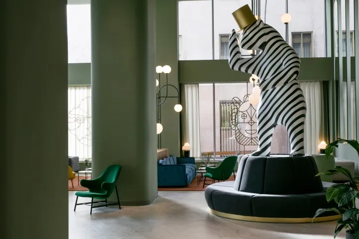 A modern lobby featuring a striking black and white striped tower sculpture.