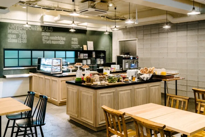 Industrial restaurant kitchen with breakfast options displayed on a counter.