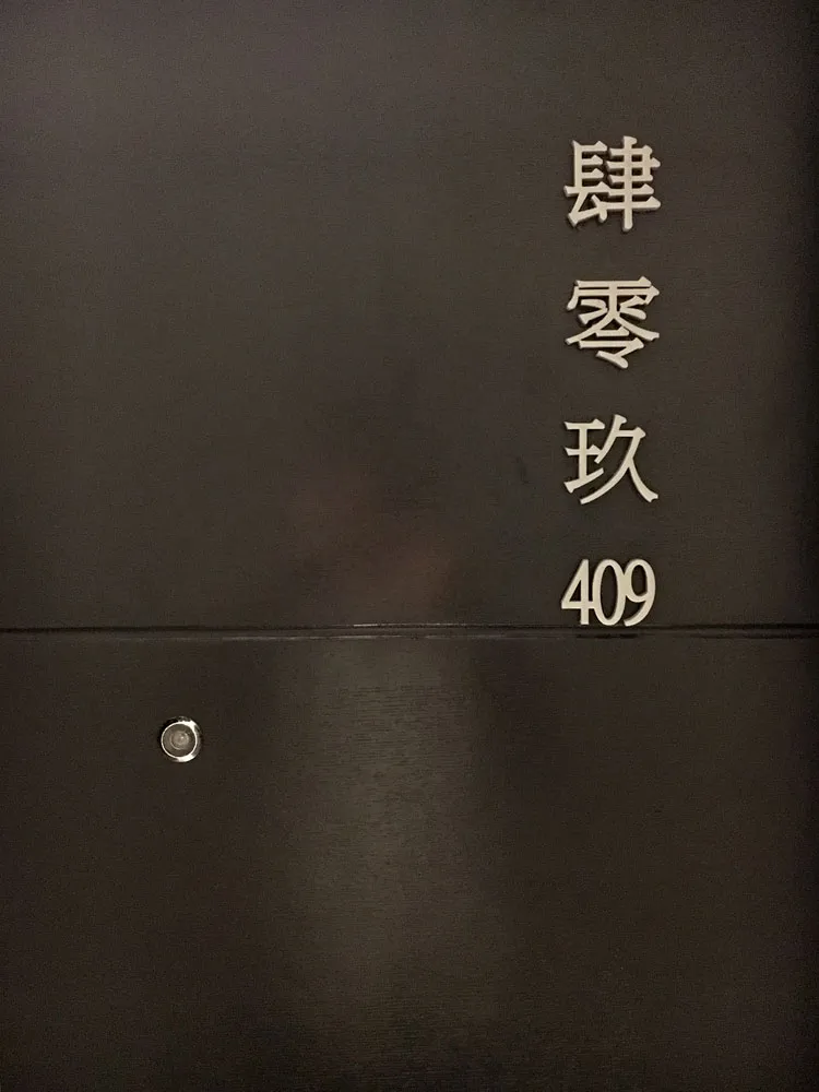 Black metal door with the number 409 and Chinese characters above it.