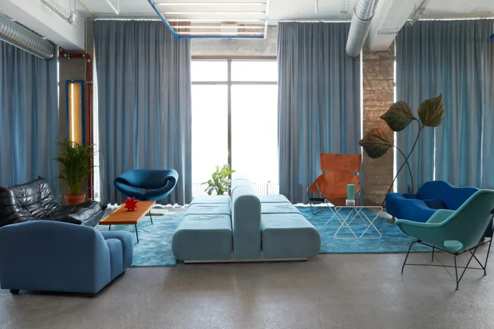 Contemporary office space featuring blue textiles and modern furniture.