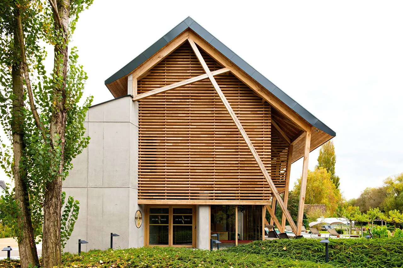 A modern building exterior featuring a wooden facade and concrete walls.