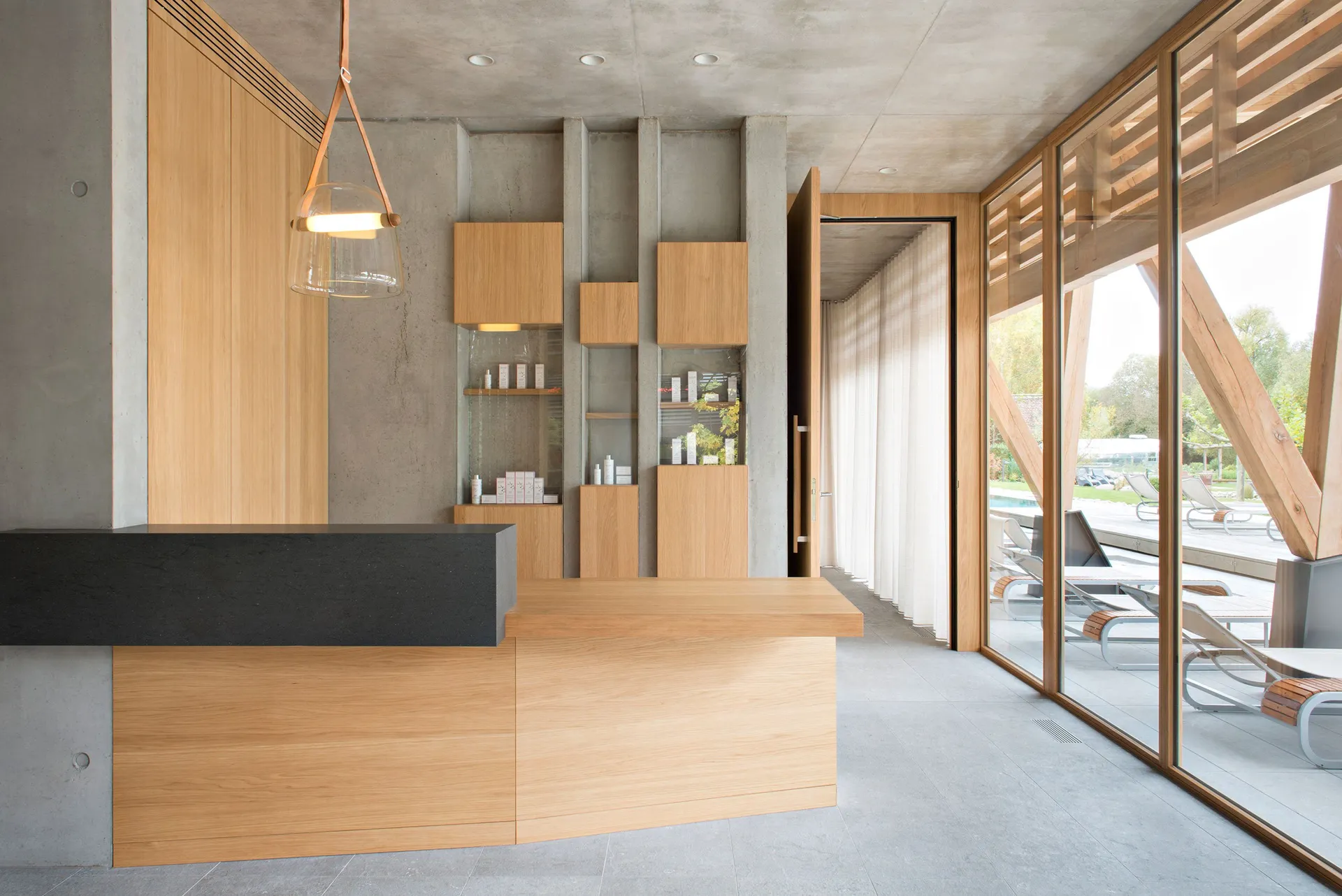 A modern interior design featuring a reception counter crafted from wood and concrete.