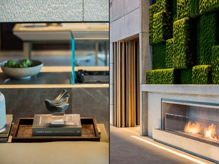 A modern living room featuring a green living wall and a fireplace.