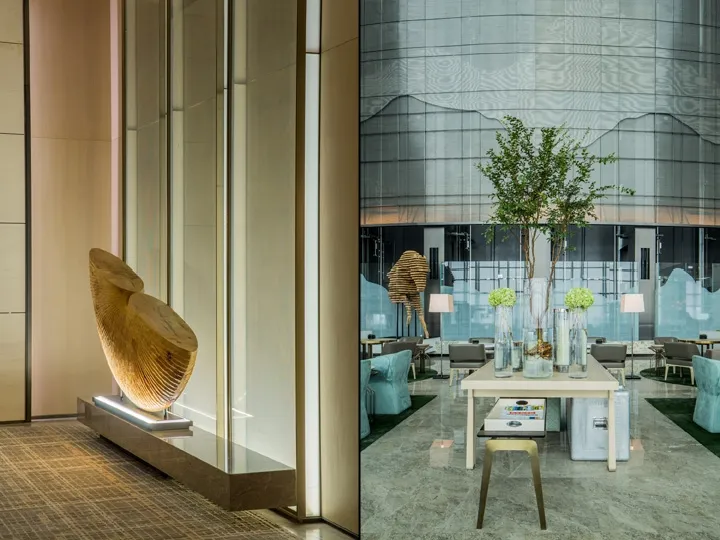 Modern lobby interior with glass tiles and sleek furniture.