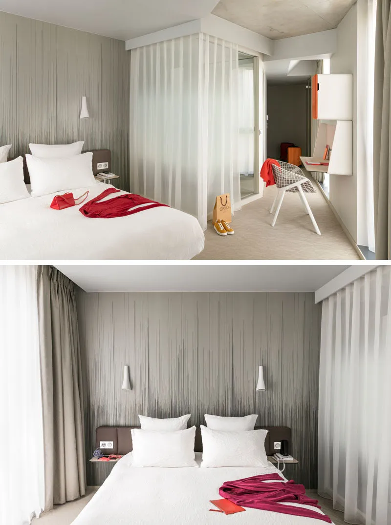 A modern minimalist hotel bedroom with a textured wallpaper accent wall and curtains, featuring a comfortable bed with white