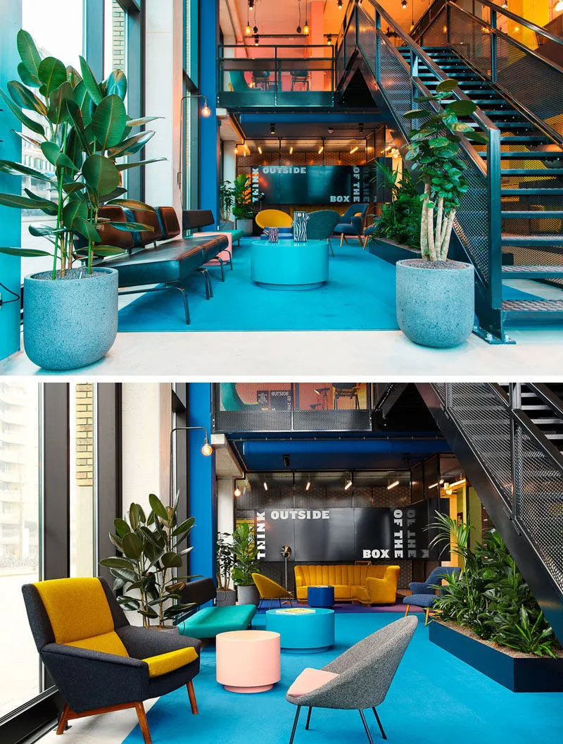 A modern office lounge area with concrete elements, indoor plants, and carpeted floors.