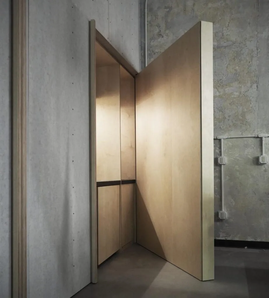 A minimalist entrance made of wood in an alternative architectural view.