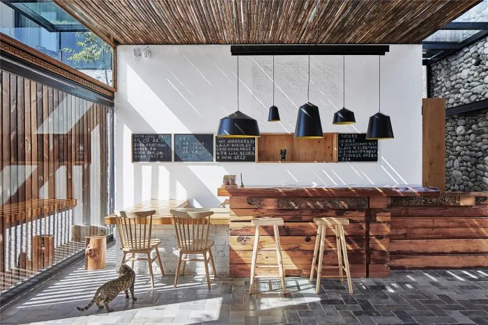 A cozy coffee shop with wooden decor and industrial lighting.