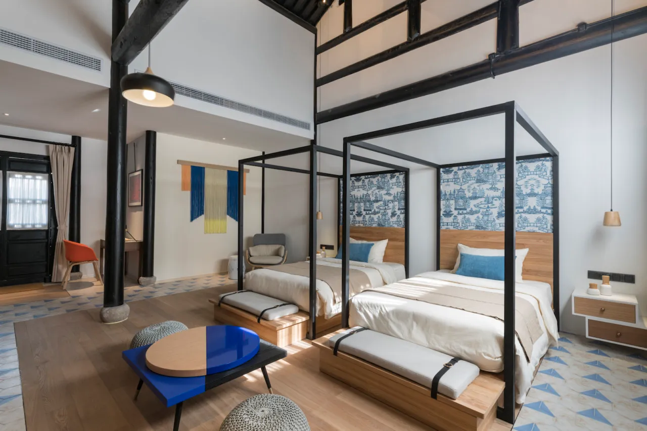 A minimalist residential room with wooden furniture and metal accents.
