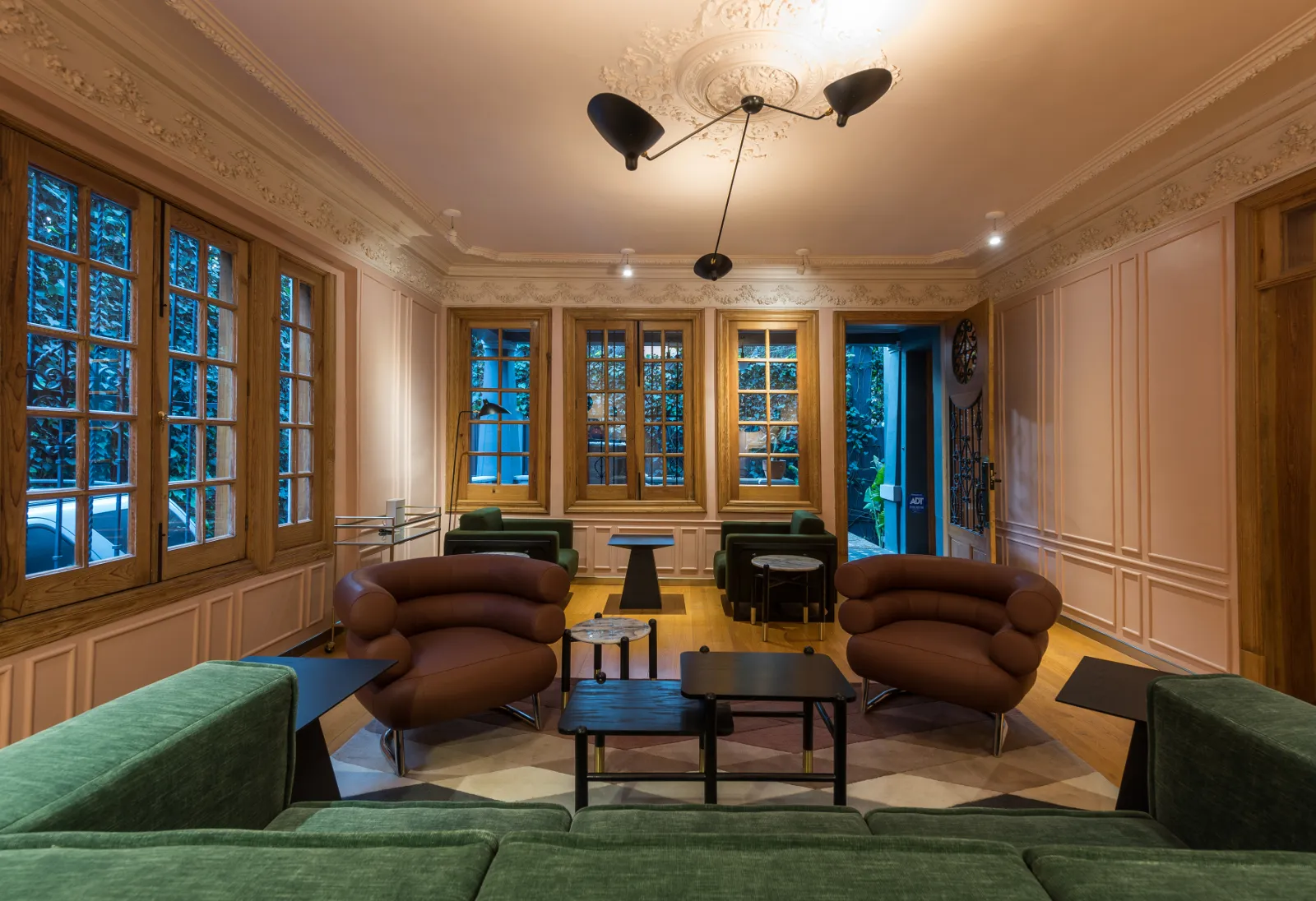 Modern lounge area with leather seating, marble tables, and wood accents