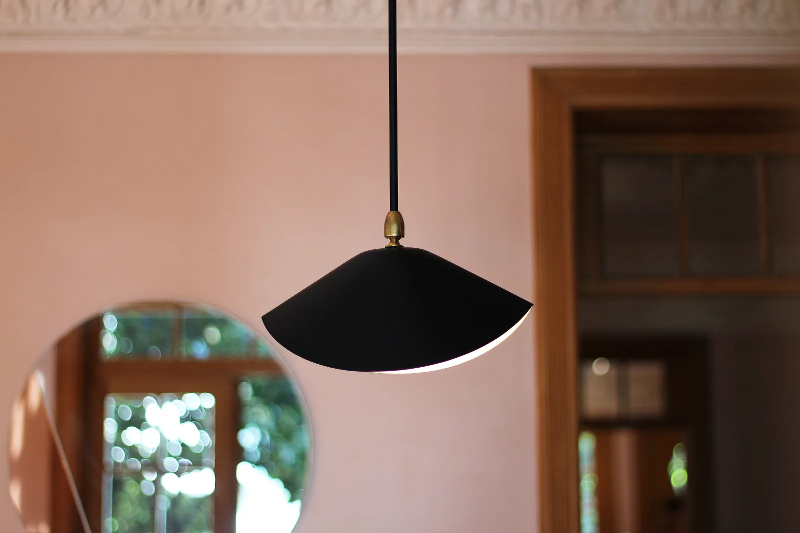 A modern interior design featuring a mid-century lighting fixture.
