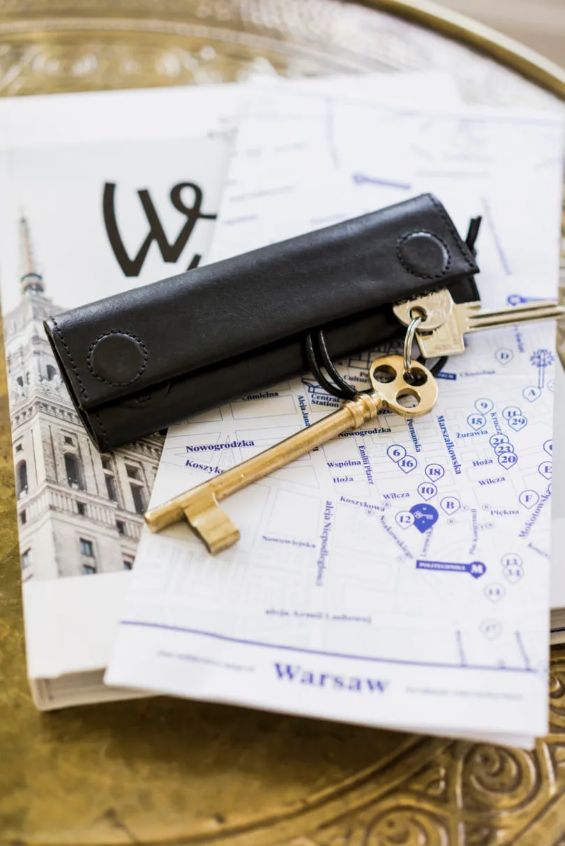 Industrial city map featuring paper documents and keys, set on a metallic tray.