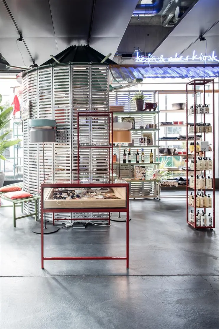 Modern retail space featuring metal and glass displays and concrete flooring