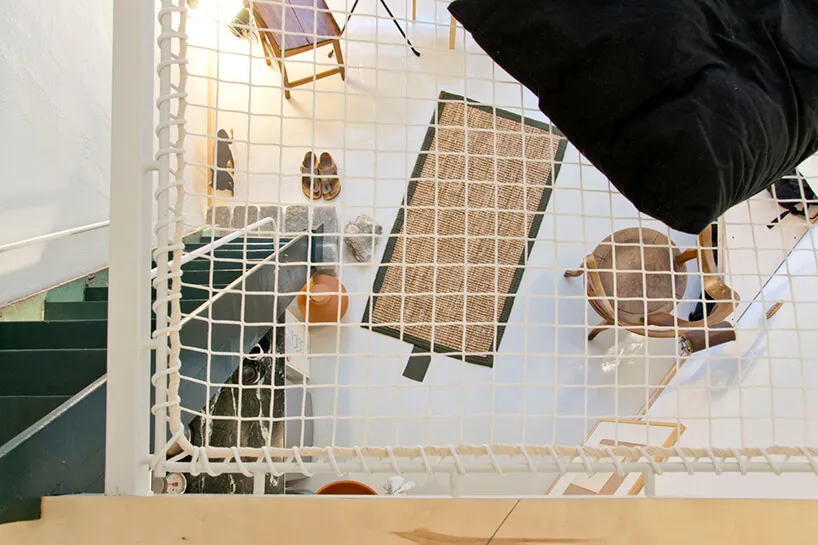 Overhead view of a room with furniture arranged using textile materials and plastics.