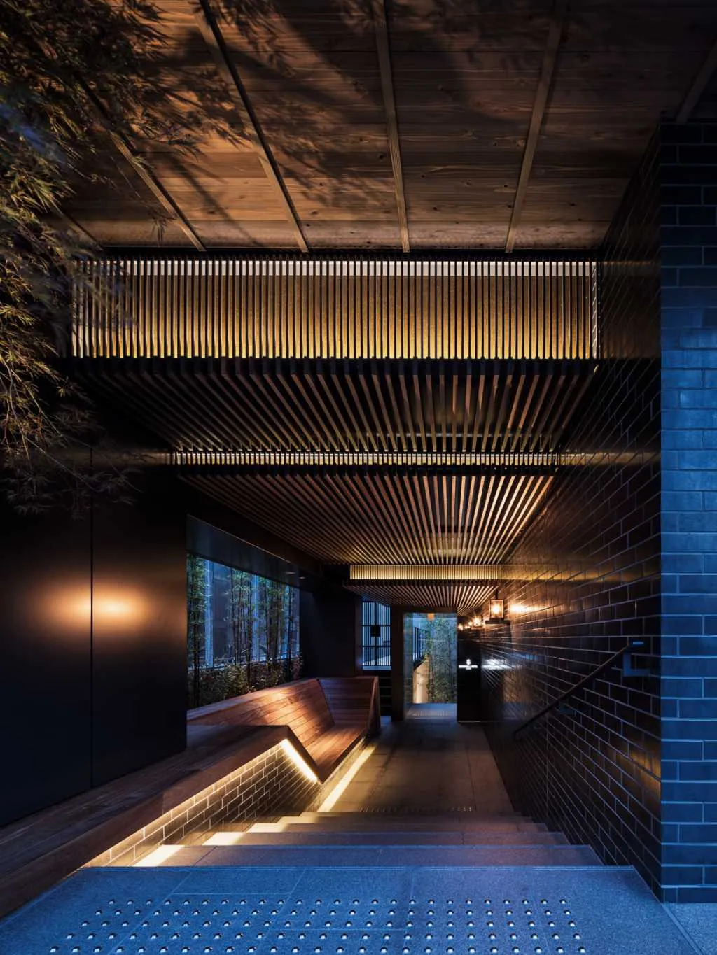Modern industrial interior design featuring brick flooring and wooden elements.