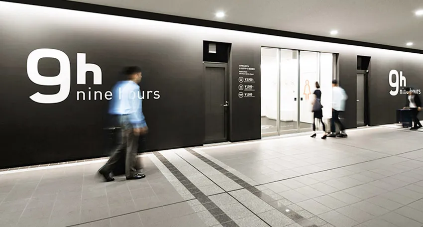 A modern retail storefront with black glass walls and a minimalist design.