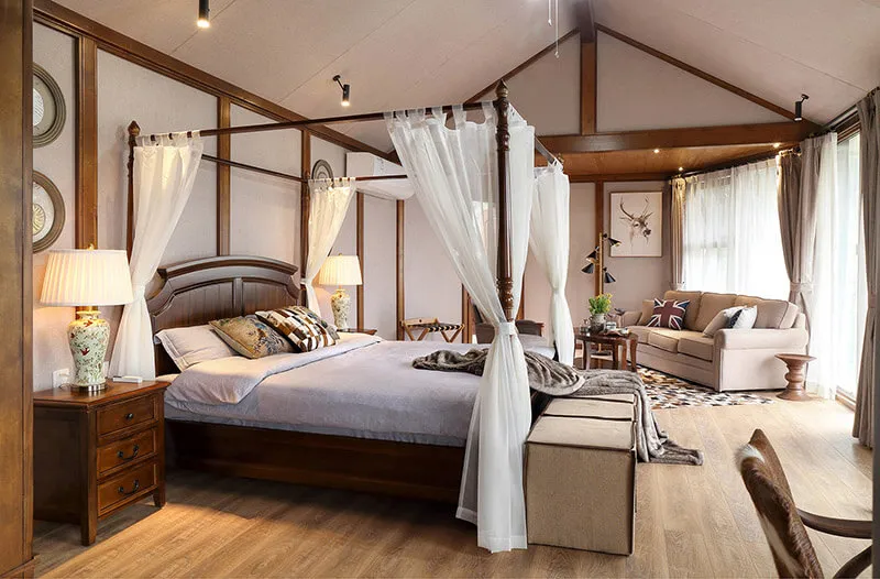 A cozy bedroom with a canopy bed, wooden furniture, and soft lighting.