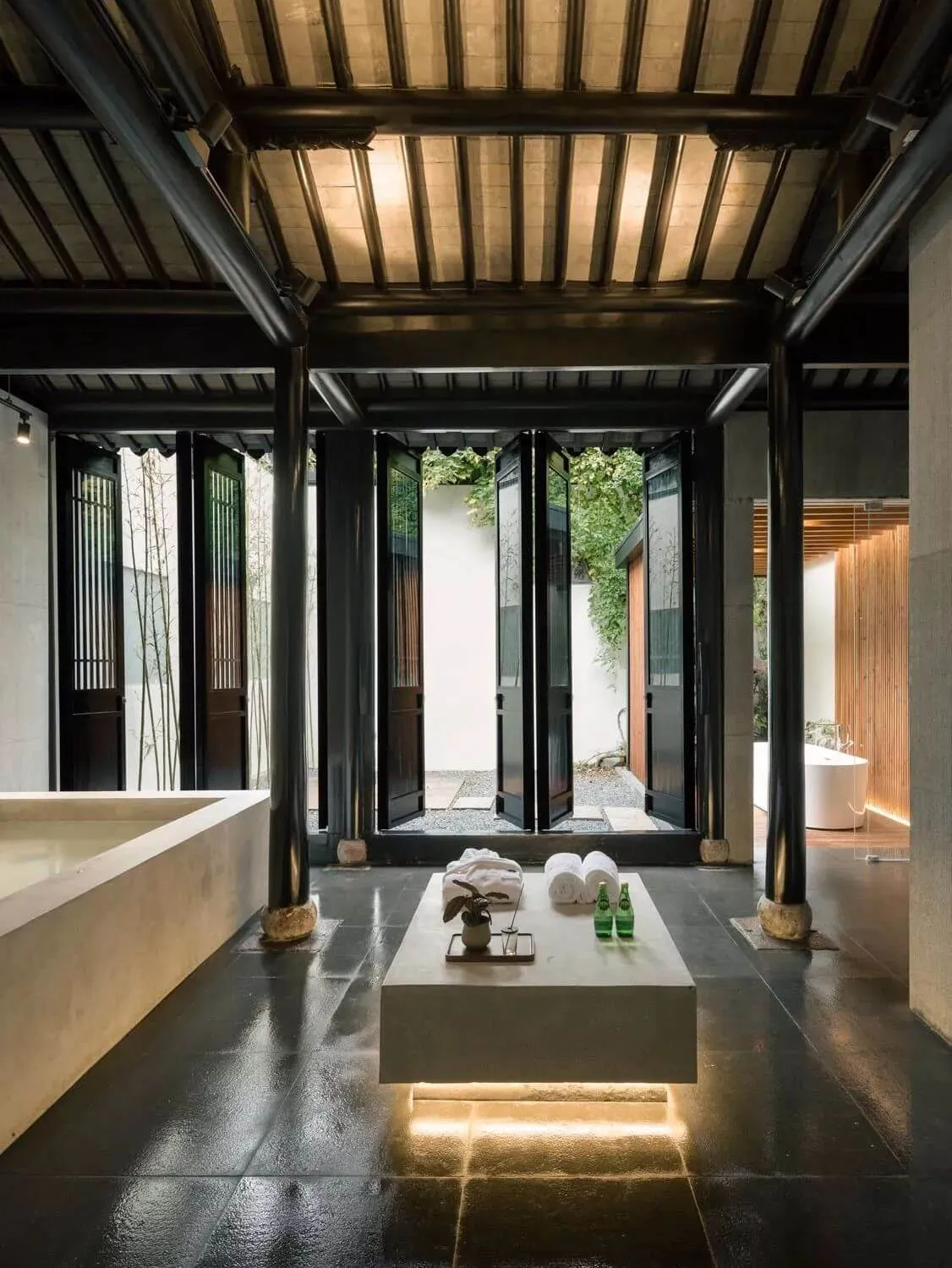 A minimalist bathroom with concrete tile flooring and timber walls.