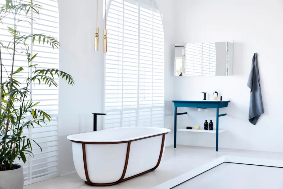 White minimalist bathroom with modern fixtures and a freestanding bathtub.