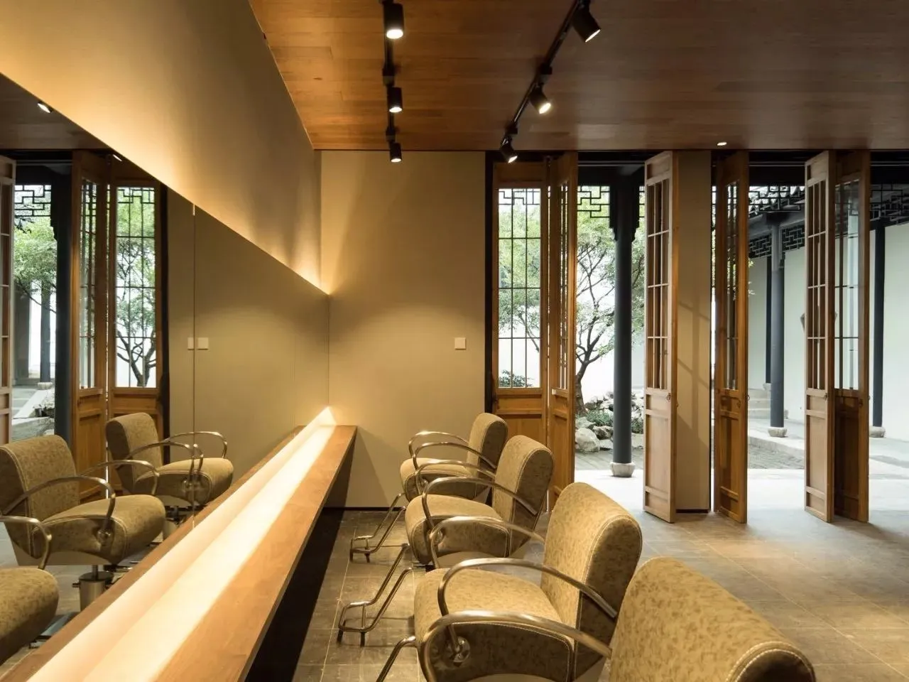 Waiting area with wooden seating and paneling in a modern style.