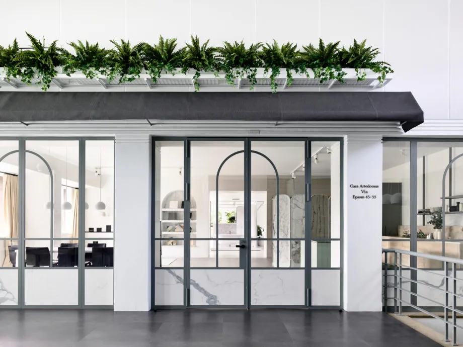 A modern retail storefront featuring glass, marble, and concrete materials.